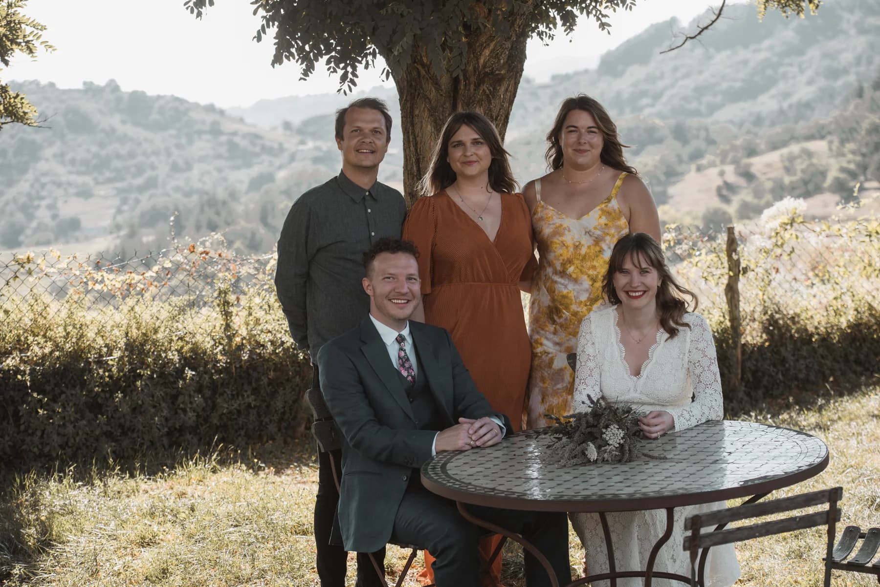 Erin & Douglas under a great tree at golden hour — destination wedding at Château de Boulogne, Ardèche