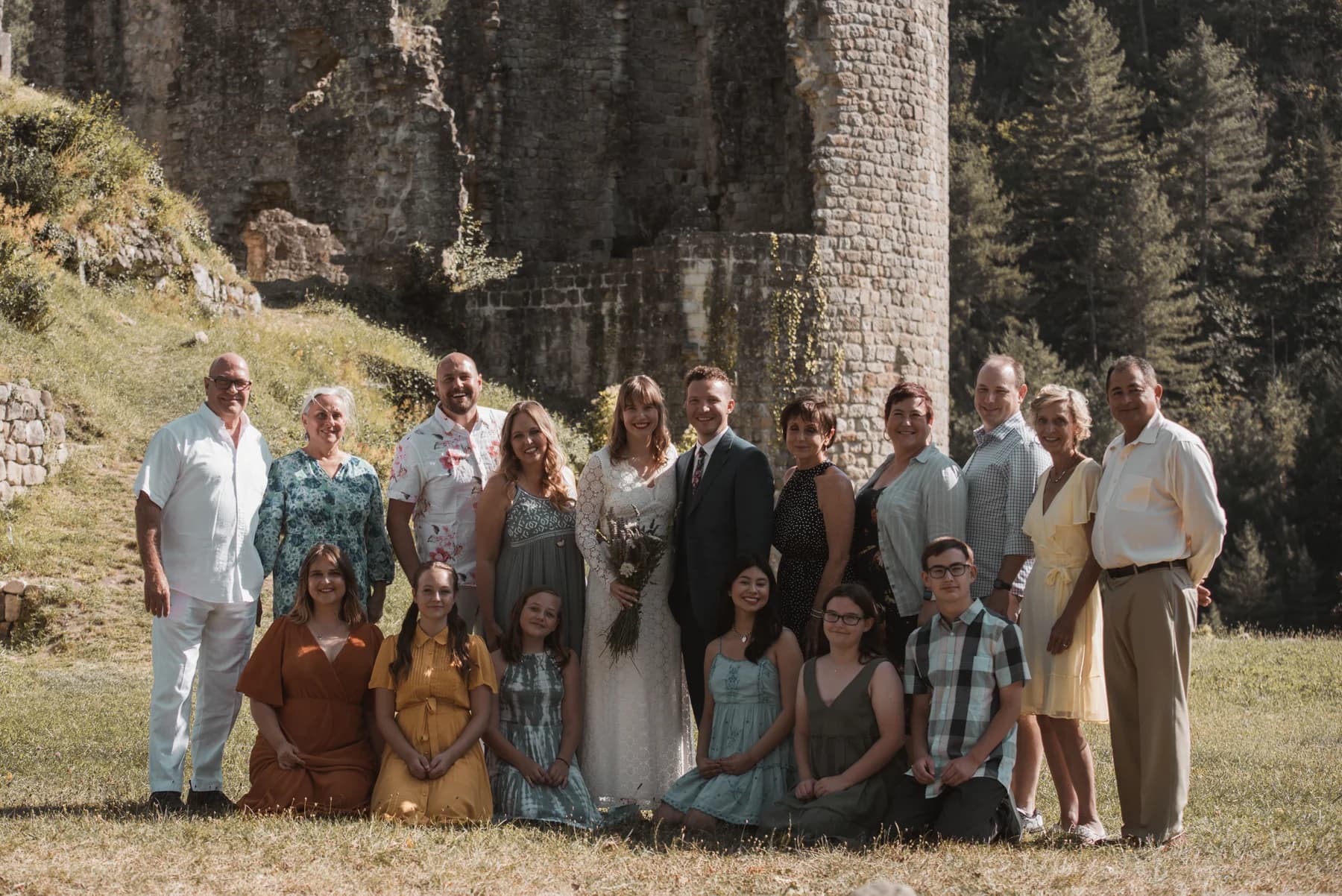 Wedding guests gathered in the château garden — destination wedding reception in Ardèche