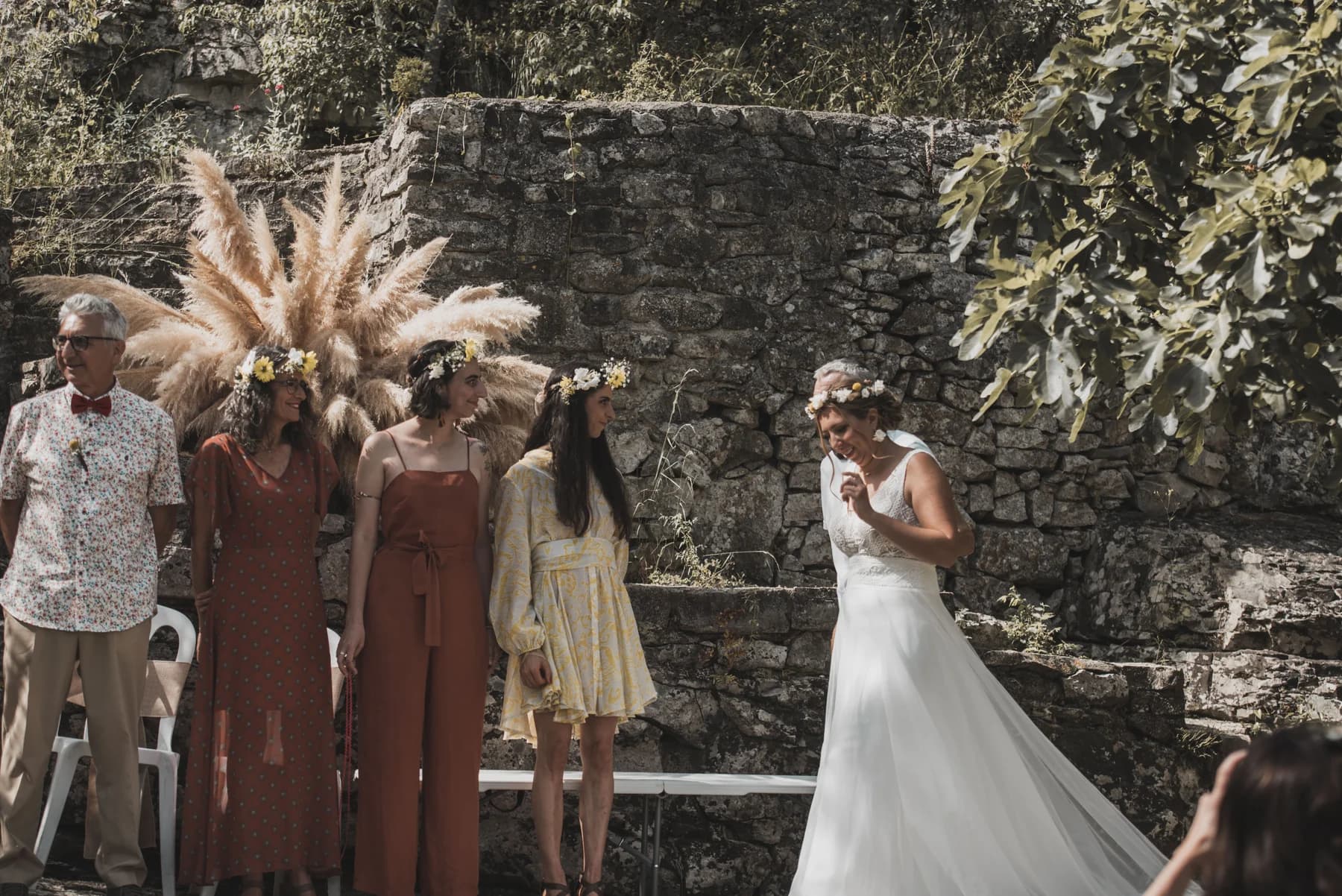 Entrée de la mariée vers l’arche de pampas — cérémonie laïque au Domaine de Bagard, Sauve