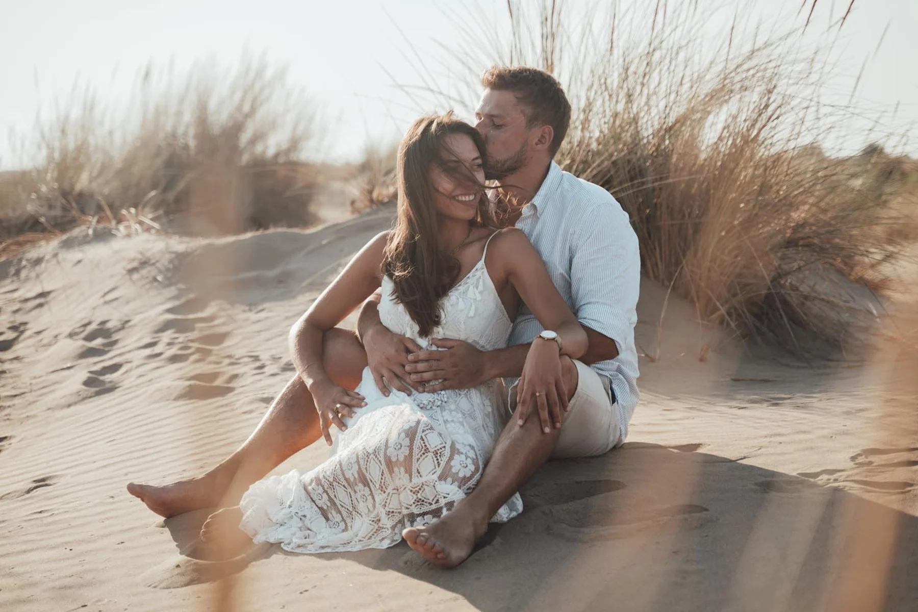 Séance photo couple dans les dunes - baiser et complicité